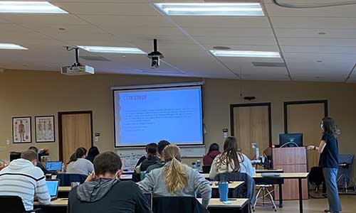 Instructor uses powerpoint projection to teach attentive students