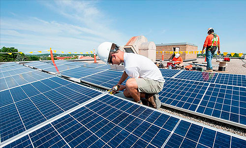 a man working on a solar panel roof.